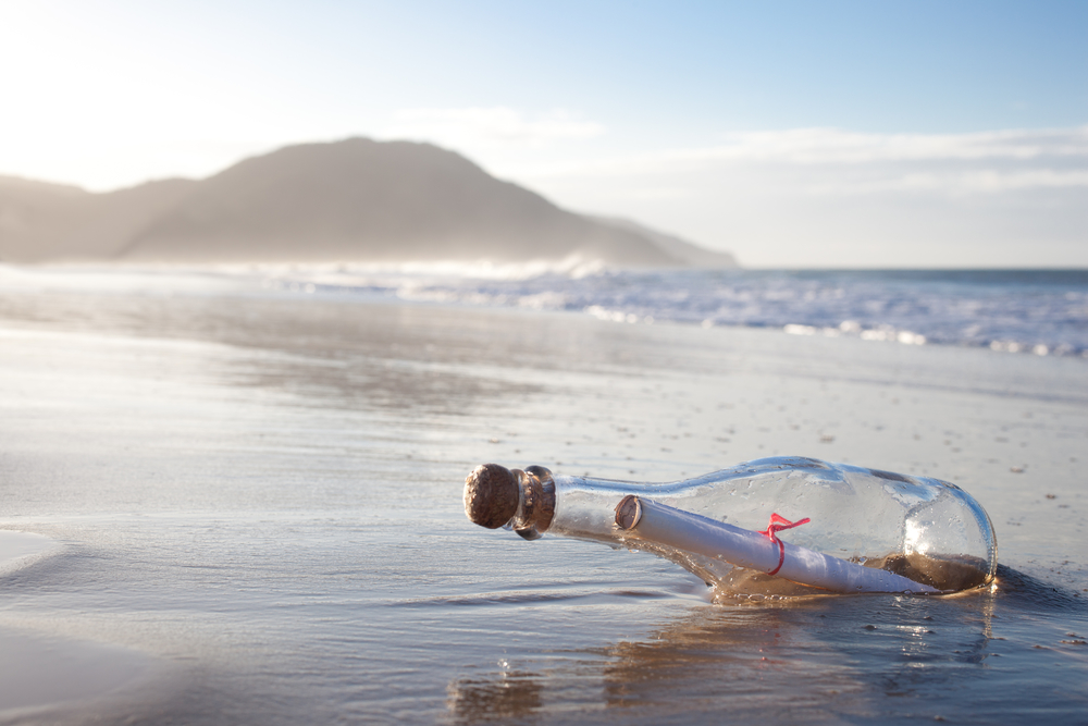 A message inside a glass bottle, washed up on a remote beach